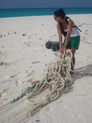 Hauling large heavy ropes from fishing vessels off the beach to reduce the possibilities of entanglement. 