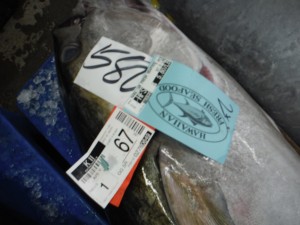 Information tags on a sold tuna. Landed by K II. 67 pounds. Auction price of $5.80 per pound. Bought by Hawaiian Fresh Seafood. 