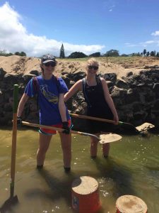 Alyssa and Ellie show off their shoveling skills.